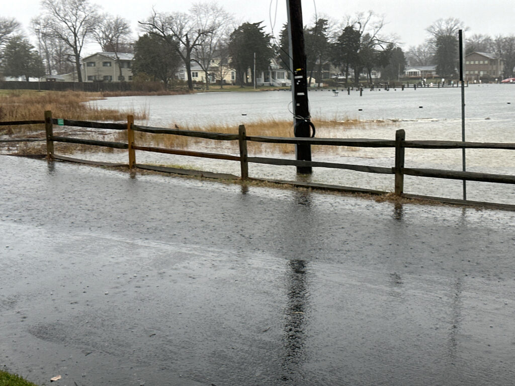 a flooded area with a fence and a wooden post (MyCoast AI)