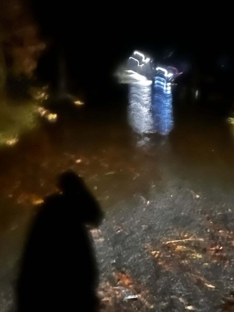a person standing in front of a waterfall at night (MyCoast AI)