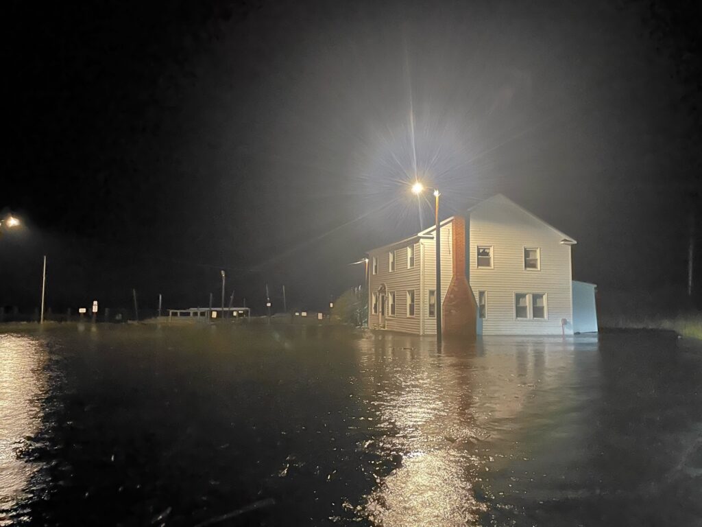 a building with a light on top by a body of water (MyCoast AI)