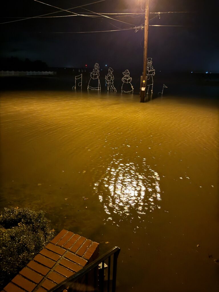 a body of water with a dock and a structure in the distance (MyCoast AI)