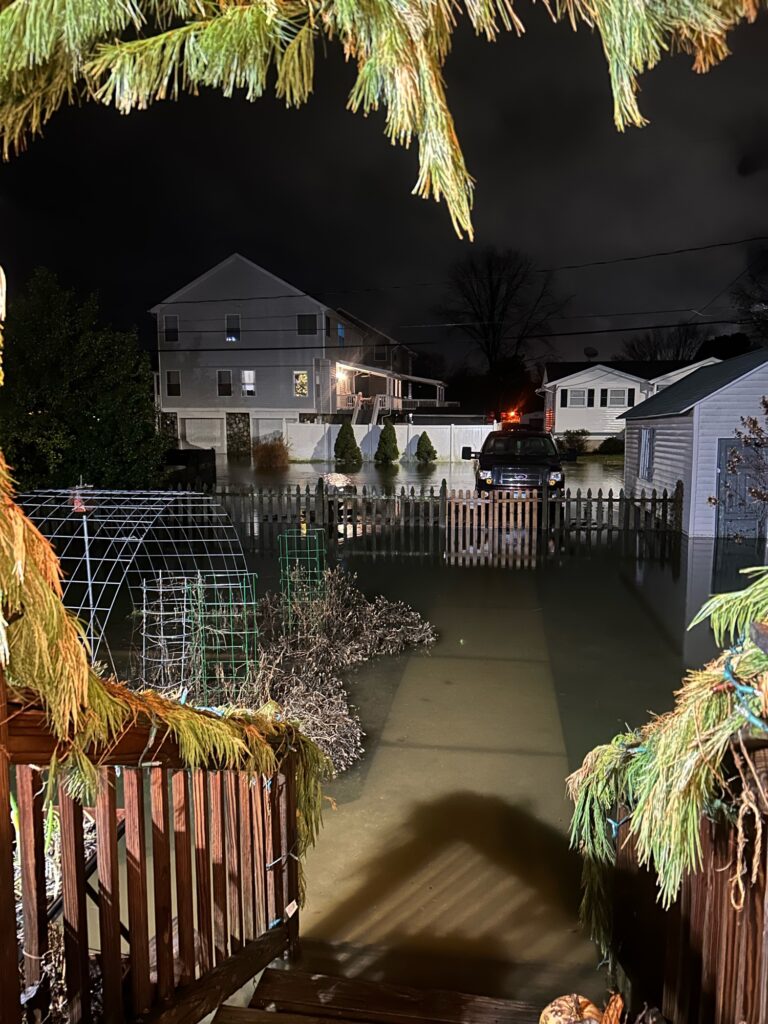 a fenced in area with houses in the background (MyCoast AI)