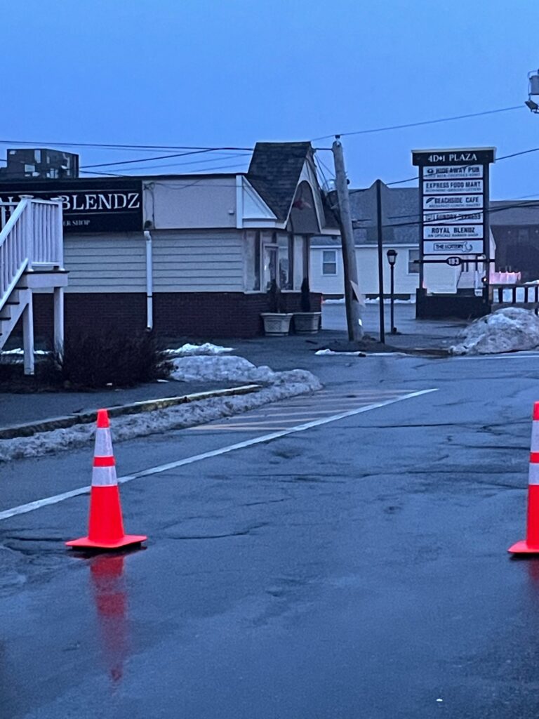 a road with a sign and cones (MyCoast AI)