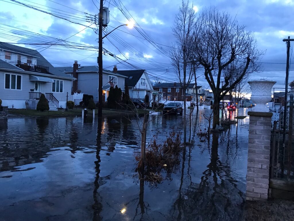 a flooded street with houses and trees (MyCoast AI)