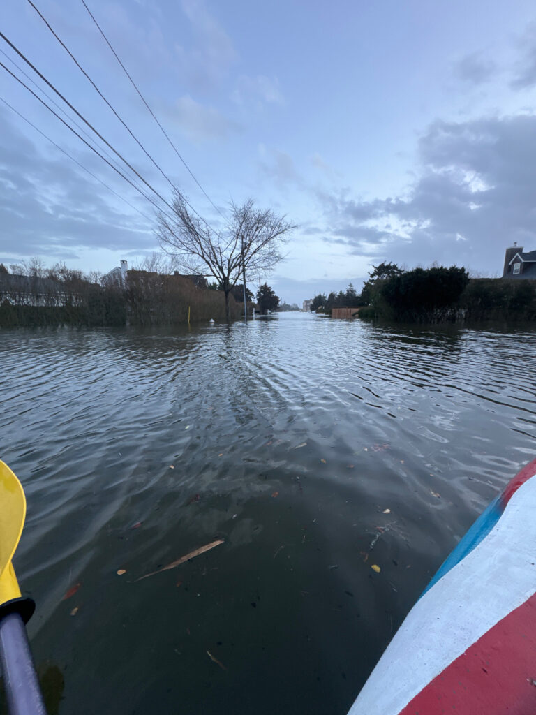 a body of water with a boat in it and buildings in the background (MyCoast AI)