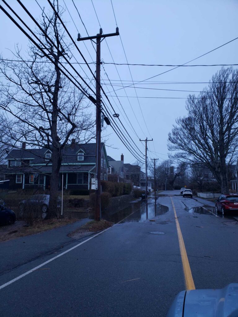 a street with power lines and houses (MyCoast AI)