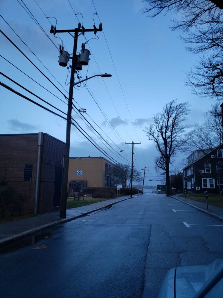 a street with power lines and buildings (MyCoast AI)