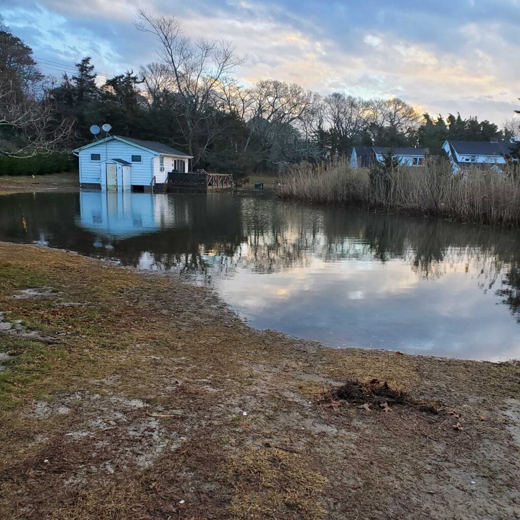 a small house on a lake (MyCoast AI)
