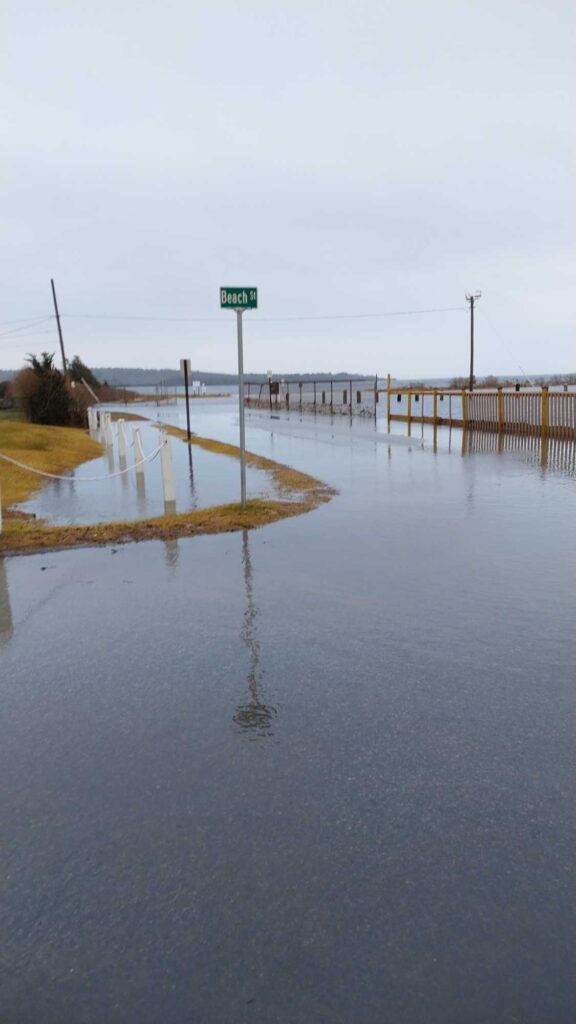 a flooded road with a sign (MyCoast AI)