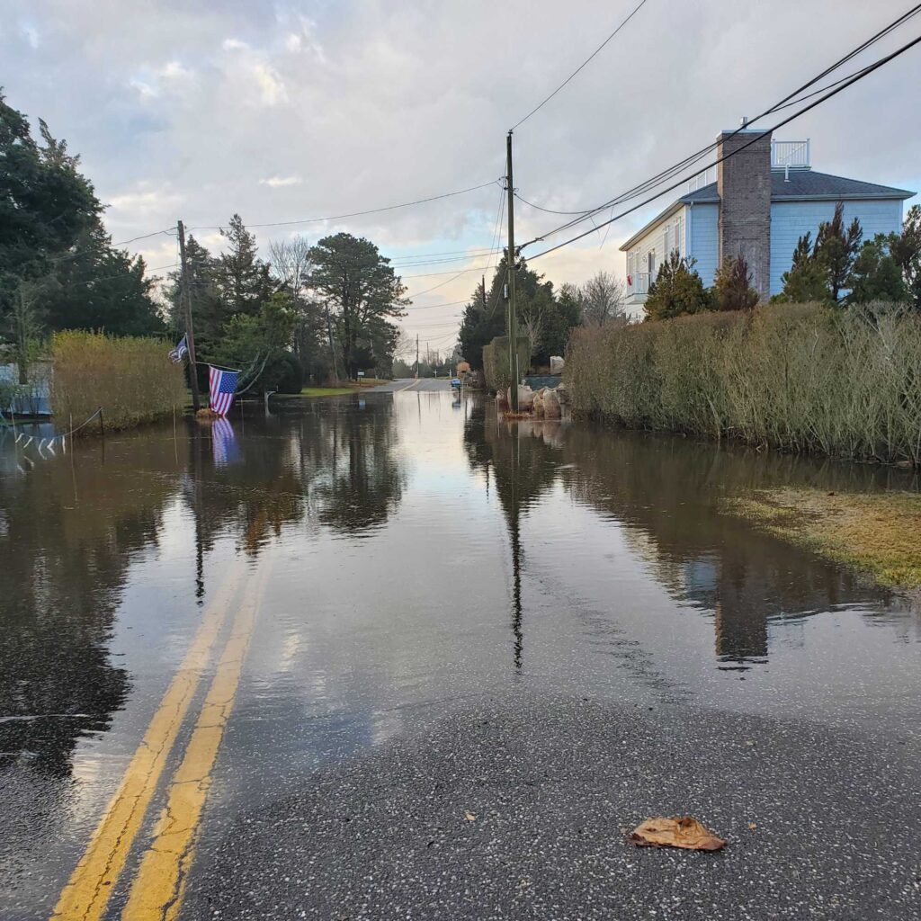 a flooded street with a building and trees on the side (MyCoast AI)