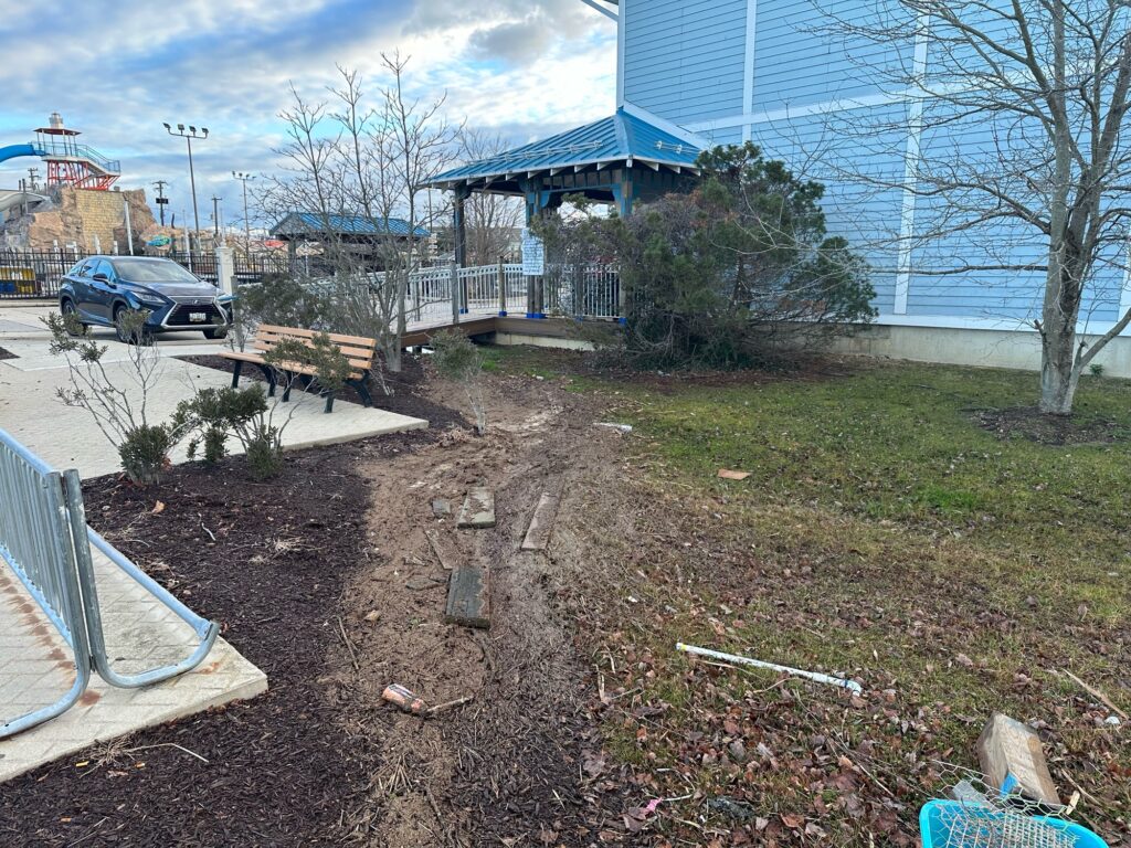 a dirt yard with a building in the background (MyCoast AI)
