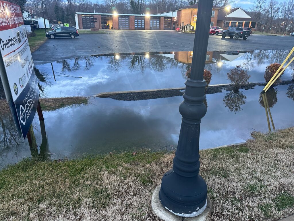 a flooded street with a sign (MyCoast AI)