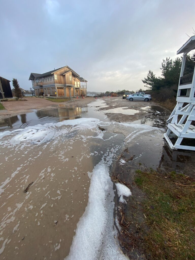 a flooded road with a house and cars (MyCoast AI)