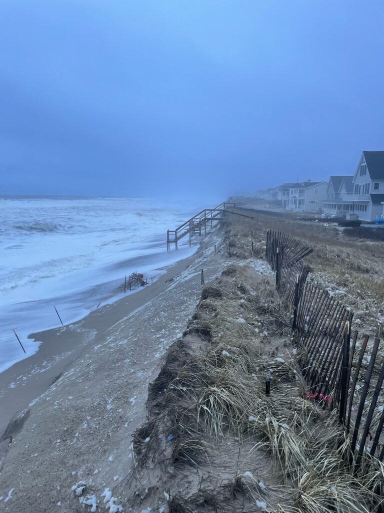 a beach with a fence and a building on the other side (MyCoast AI)