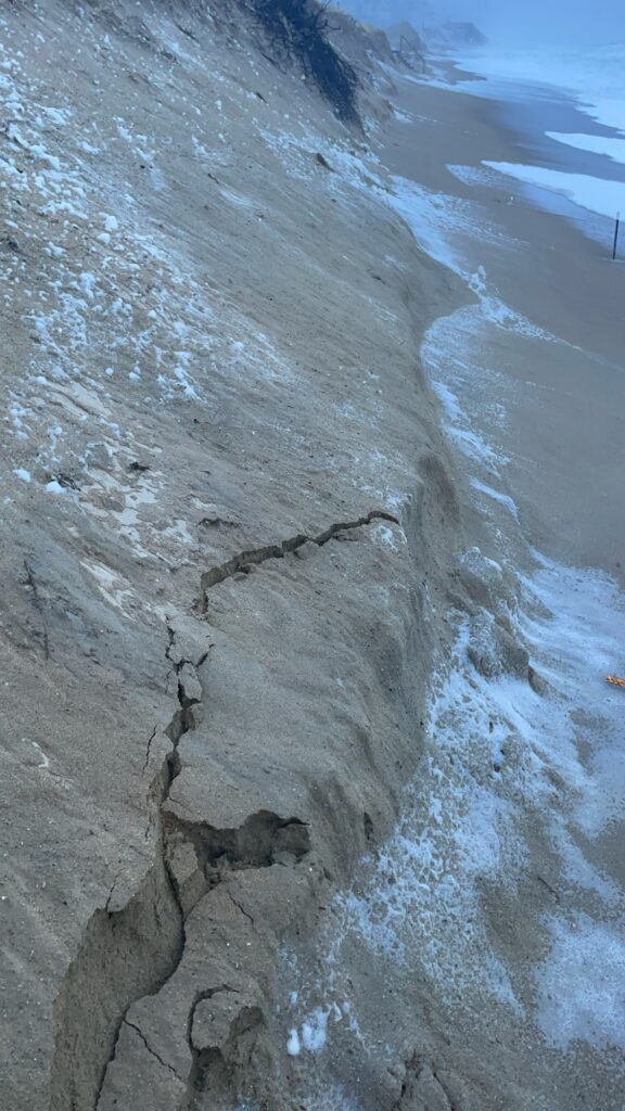 a rocky beach with a large hole in the sand (MyCoast AI)