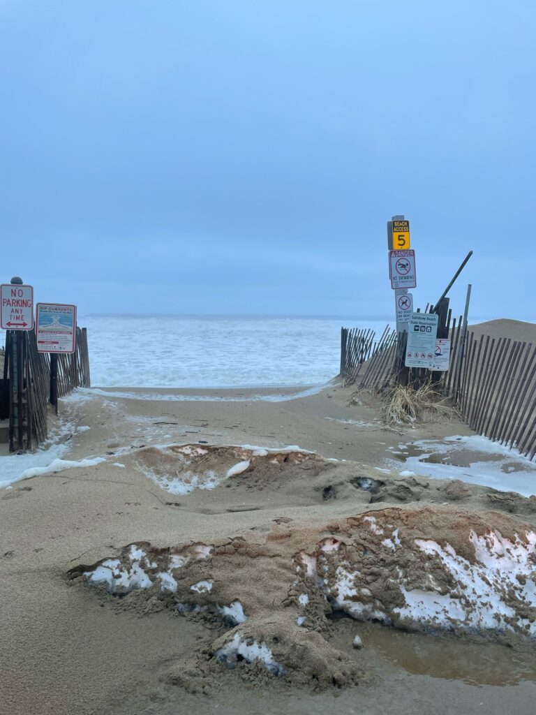 a beach with signs and a fence (MyCoast AI)
