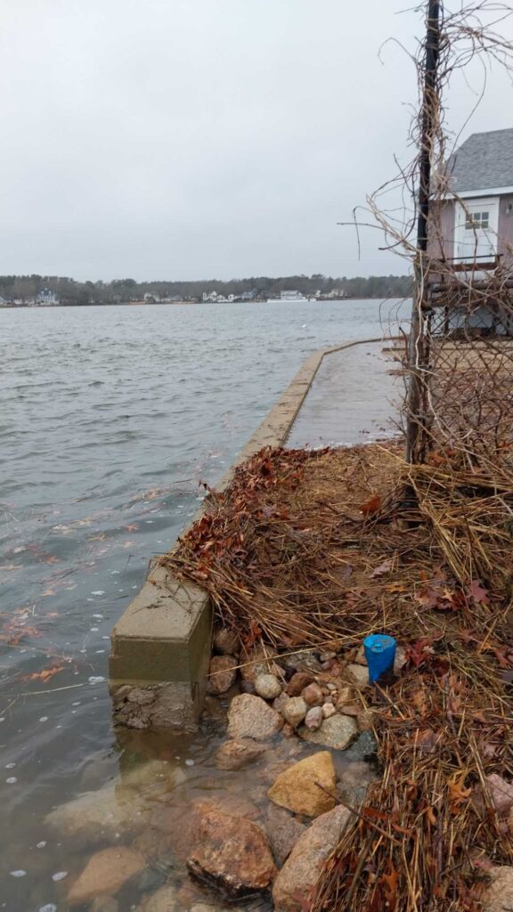 a body of water with a dock and a house in the background (MyCoast AI)