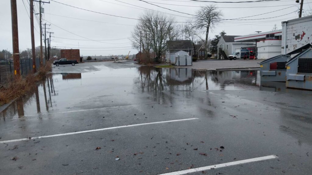a flooded street with cars and buildings (MyCoast AI)