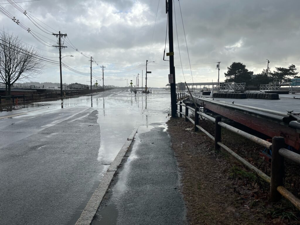 a wet road with a row of boats on it (MyCoast AI)