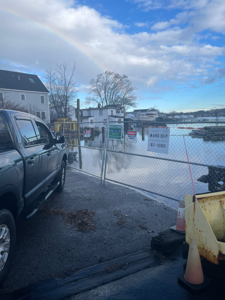 a car parked on a street next to a fence and a building (MyCoast AI)