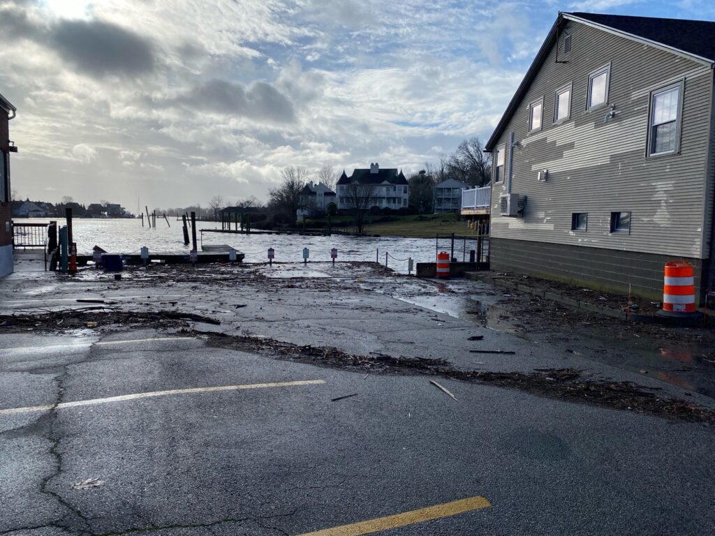 a road with a puddle and buildings on the side (MyCoast AI)