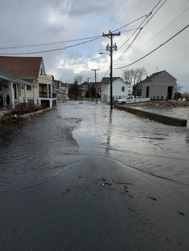 a flooded street with houses and power lines (MyCoast AI)