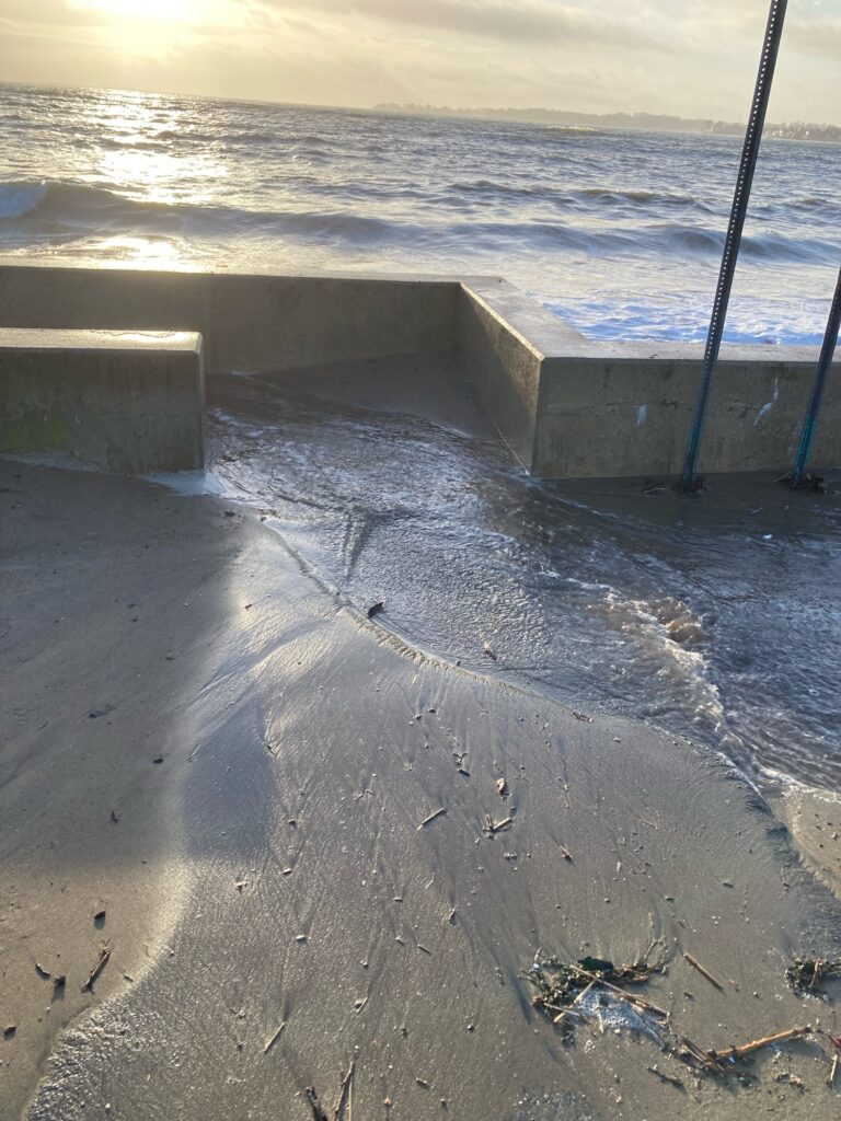 a concrete wall next to a body of water (MyCoast AI)