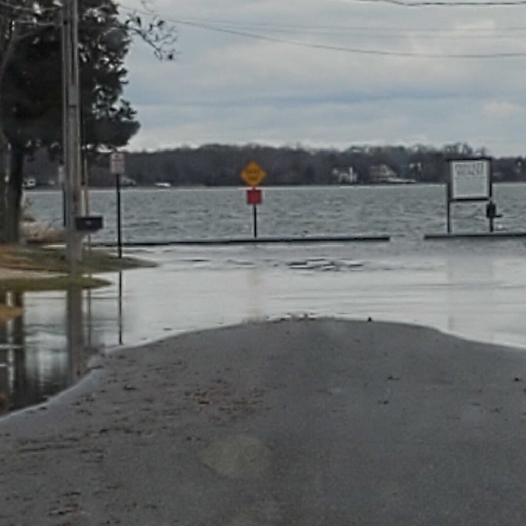 a flooded road with a sign (MyCoast AI)
