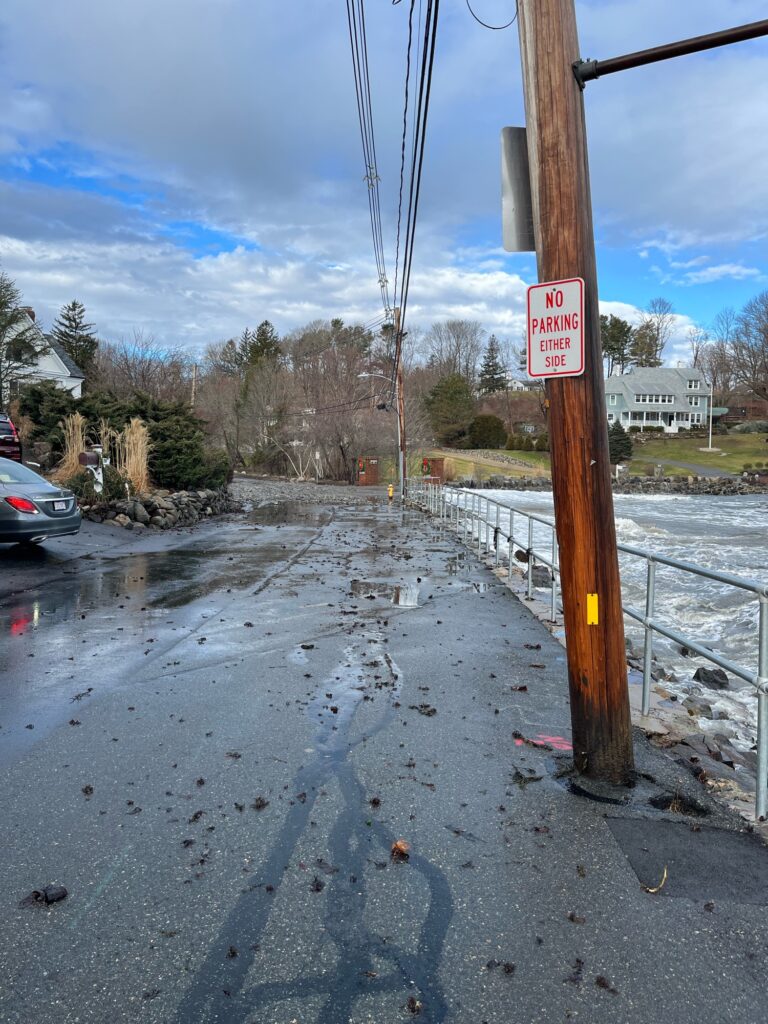 a flooded street with a sign (MyCoast AI)