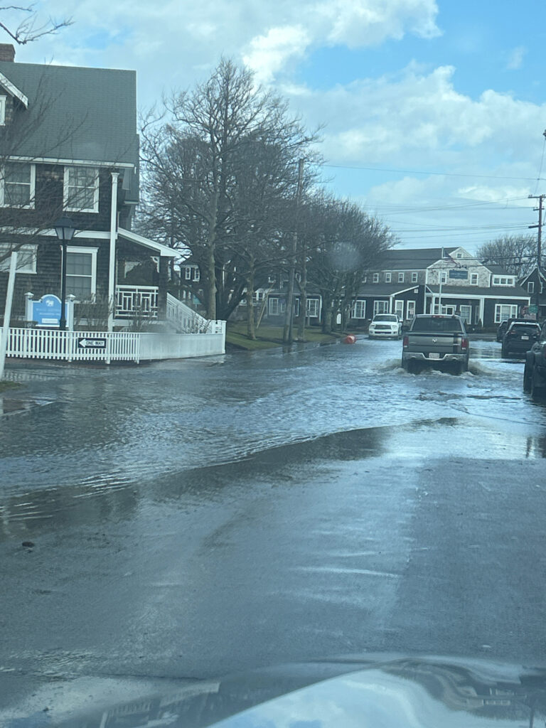 a flooded street with cars and houses (MyCoast AI)