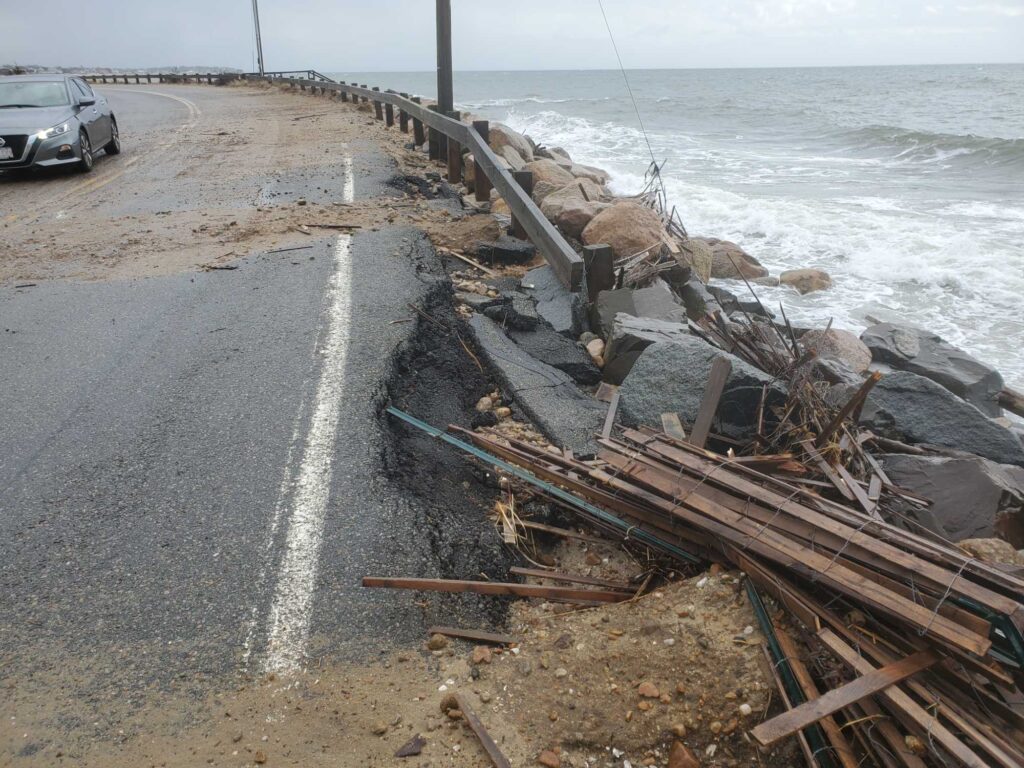 a road with a pile of wood on the side and a car parked on the side (MyCoast AI)