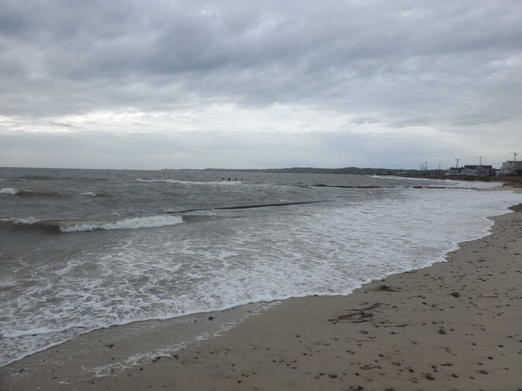 a beach with waves crashing on it (MyCoast AI)