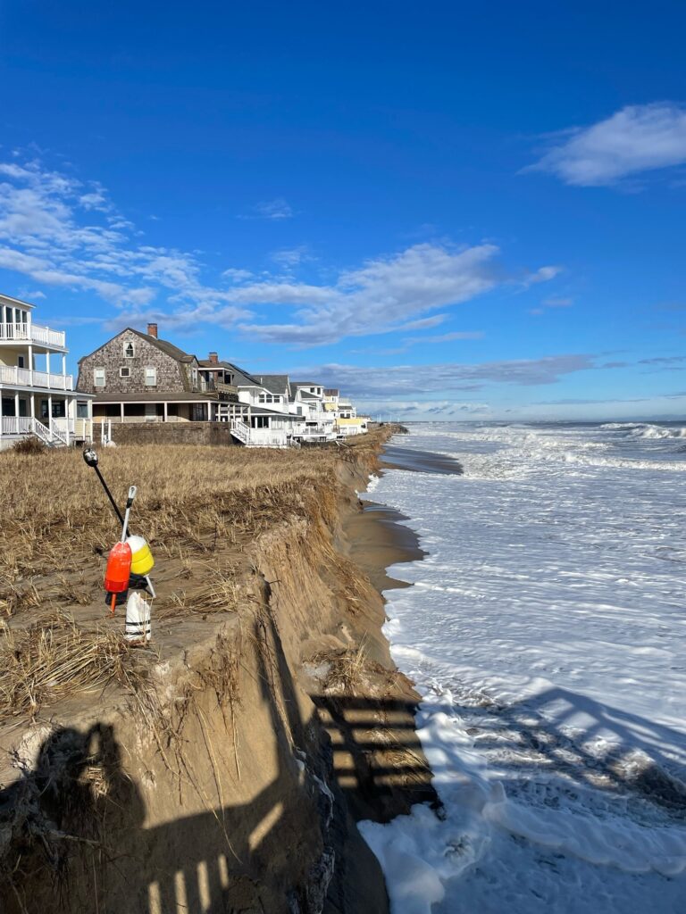 a person standing on a cliff by the water (MyCoast AI)