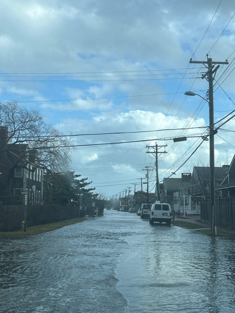 a flooded street with cars and power lines (MyCoast AI)