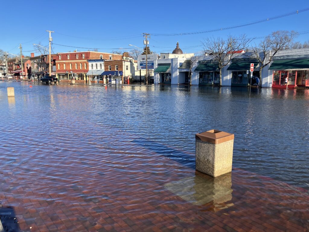 a brick structure in a body of water with buildings in the background (MyCoast AI)