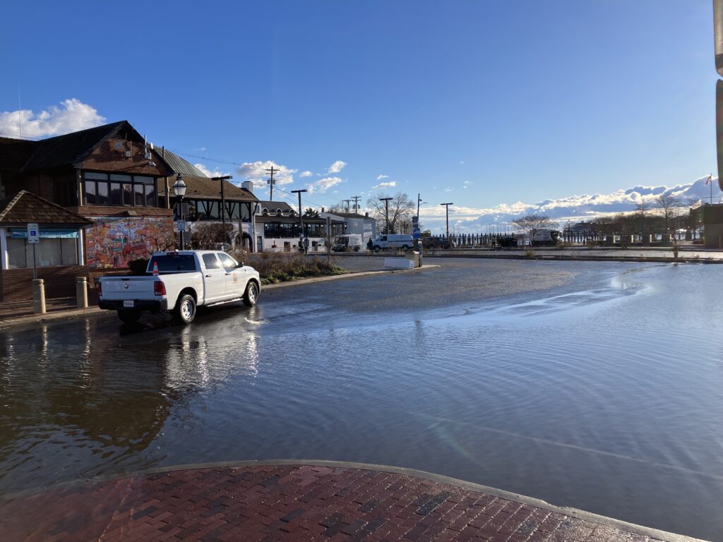 a truck driving through a flooded street (MyCoast AI)