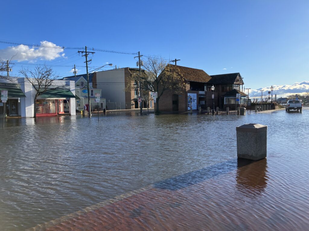 a flooded street with buildings and a boat (MyCoast AI)