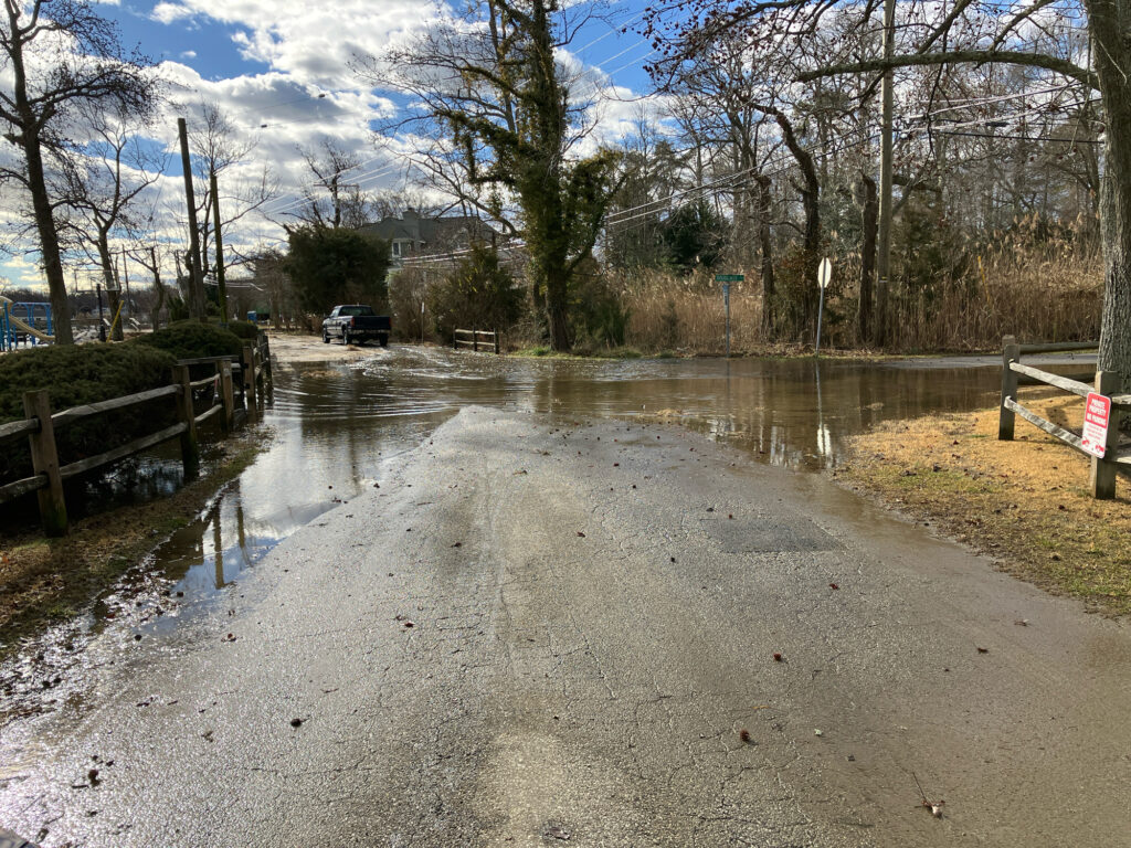 a flooded road with a car driving (MyCoast AI)