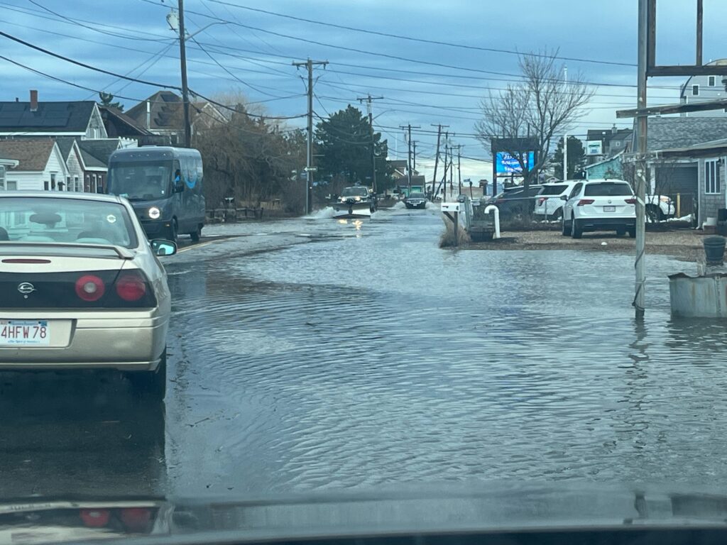 a flooded street with cars and houses (MyCoast AI)