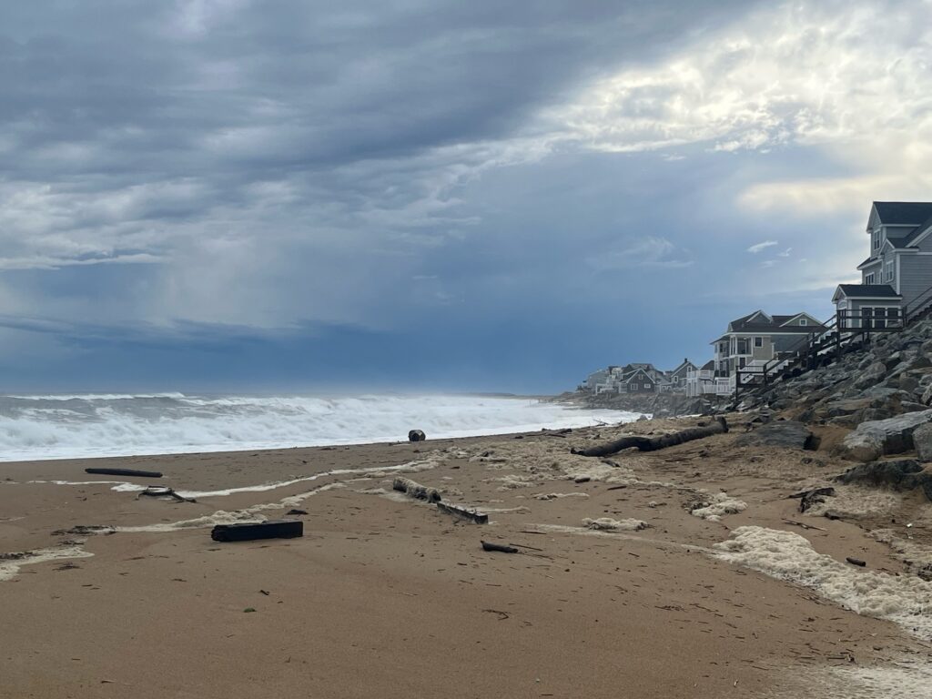 a beach with rocks and a building (MyCoast AI)