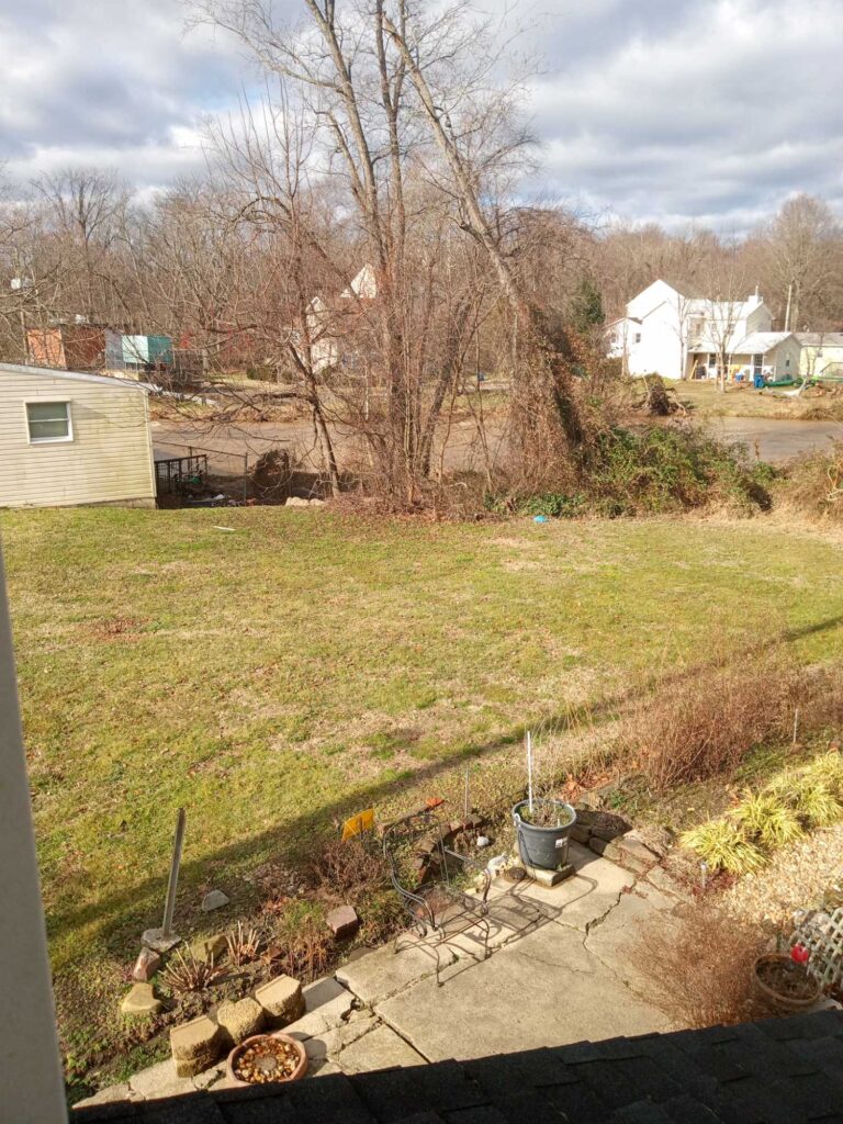 a yard with a small garden (MyCoast AI)