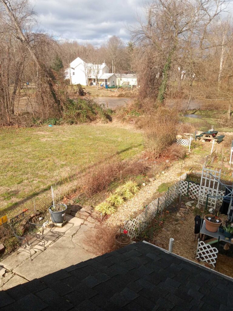 a roof with a yard and a house in the background (MyCoast AI)