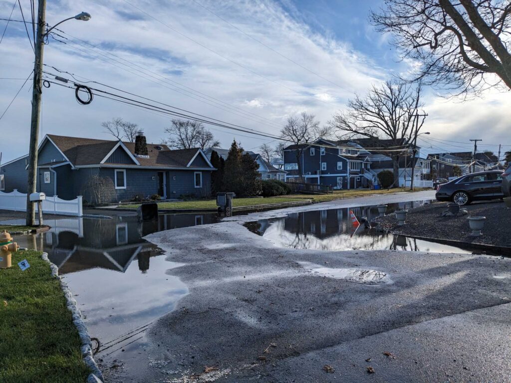 a street with houses and a puddle (MyCoast AI)