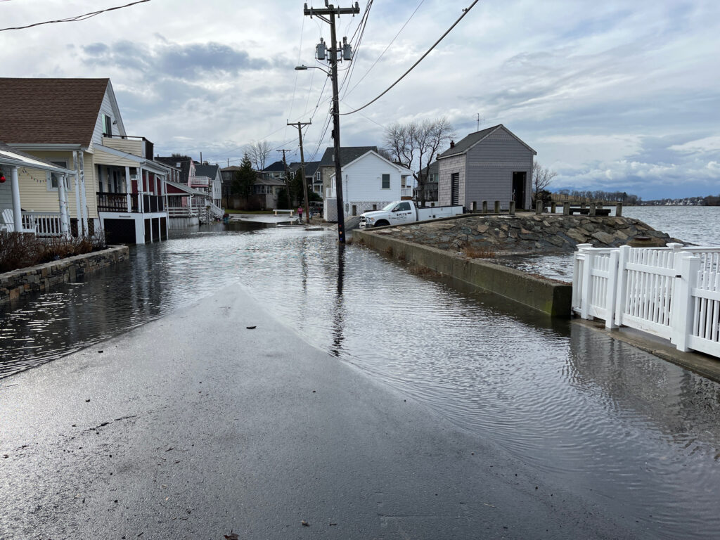 a flooded street with houses and cars (MyCoast AI)