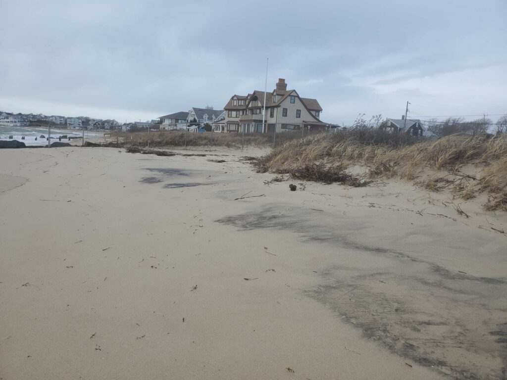 a sandy beach with a house in the background (MyCoast AI)