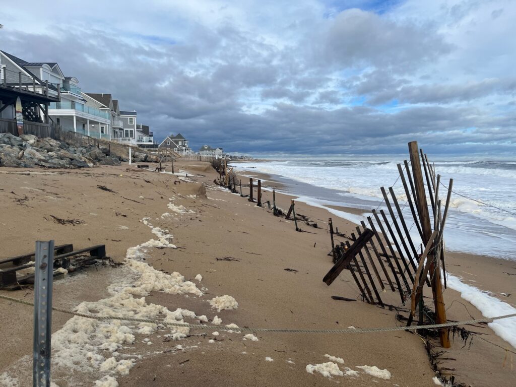 a beach with a fence and a building on the side (MyCoast AI)