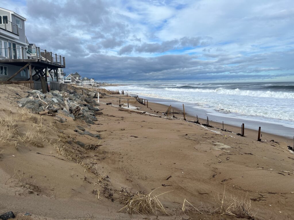 a beach with a building and a fence (MyCoast AI)