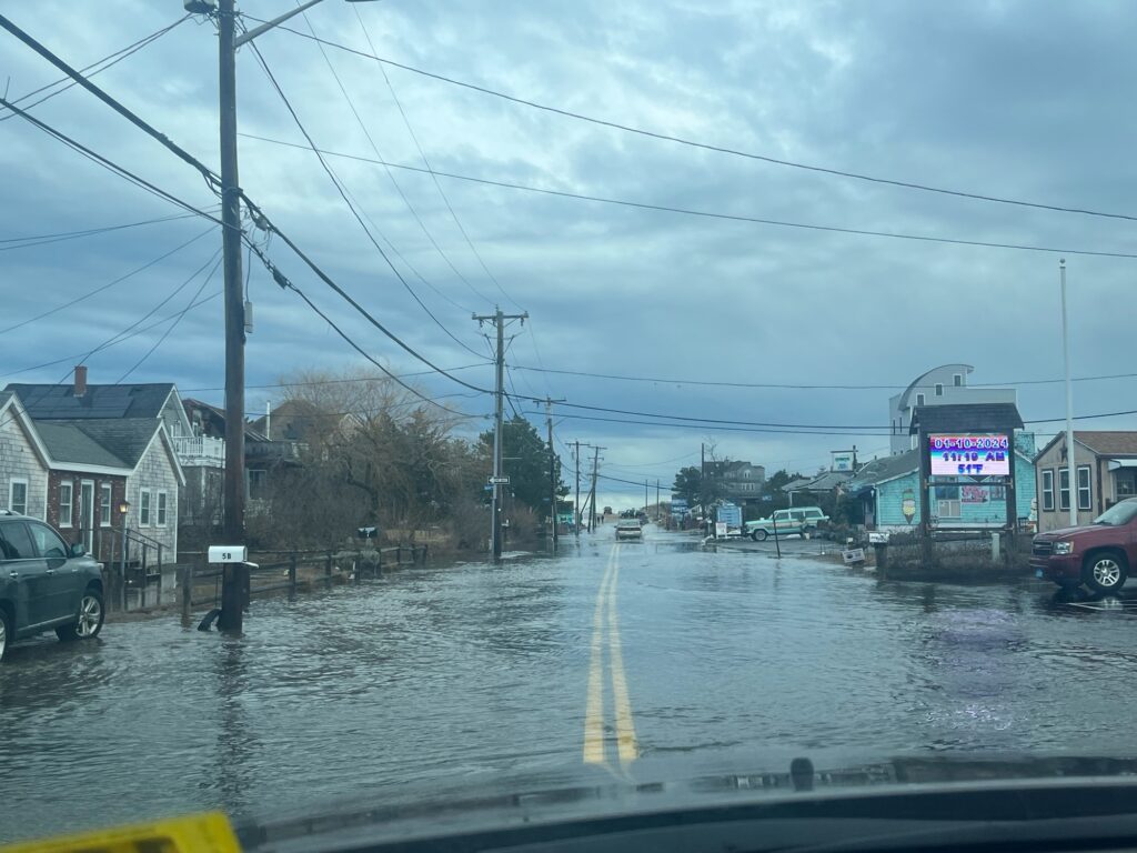 a flooded street with cars and buildings (MyCoast AI)
