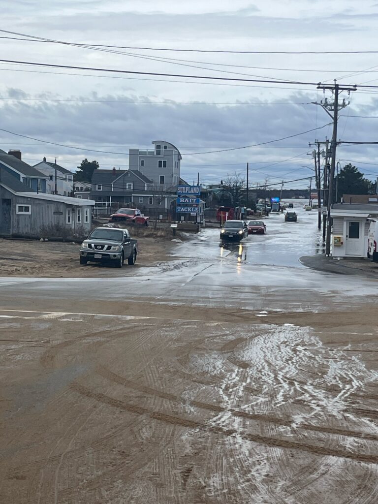 a flooded street with cars and buildings (MyCoast AI)