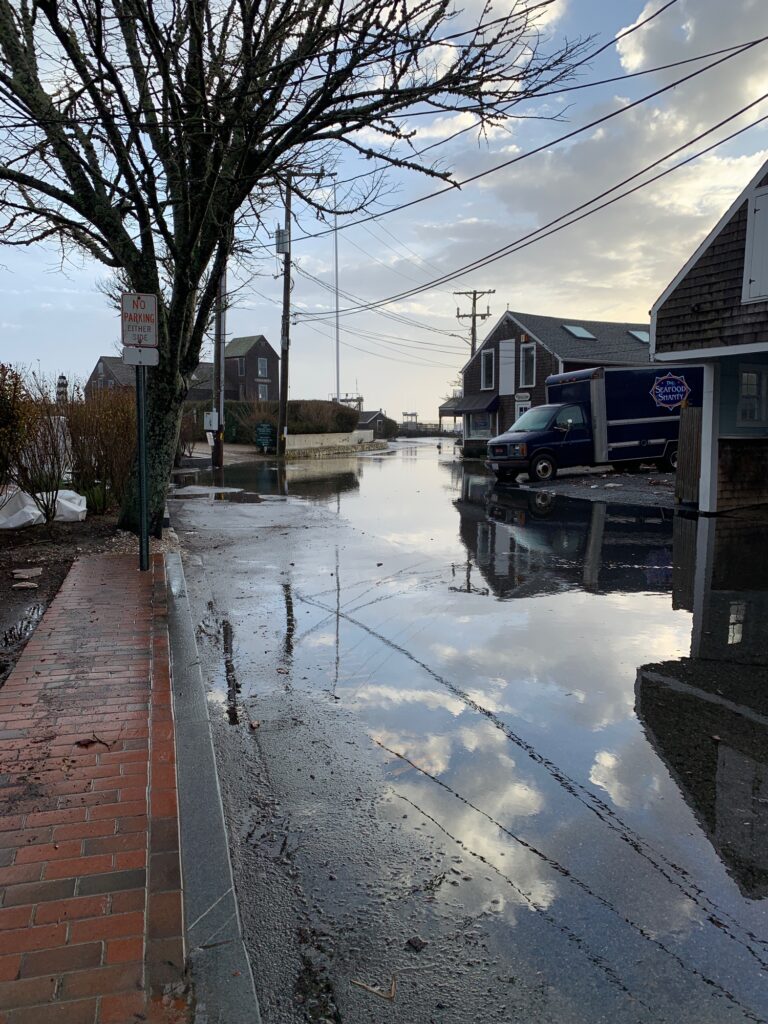 a flooded street with a truck parked on the side (MyCoast AI)