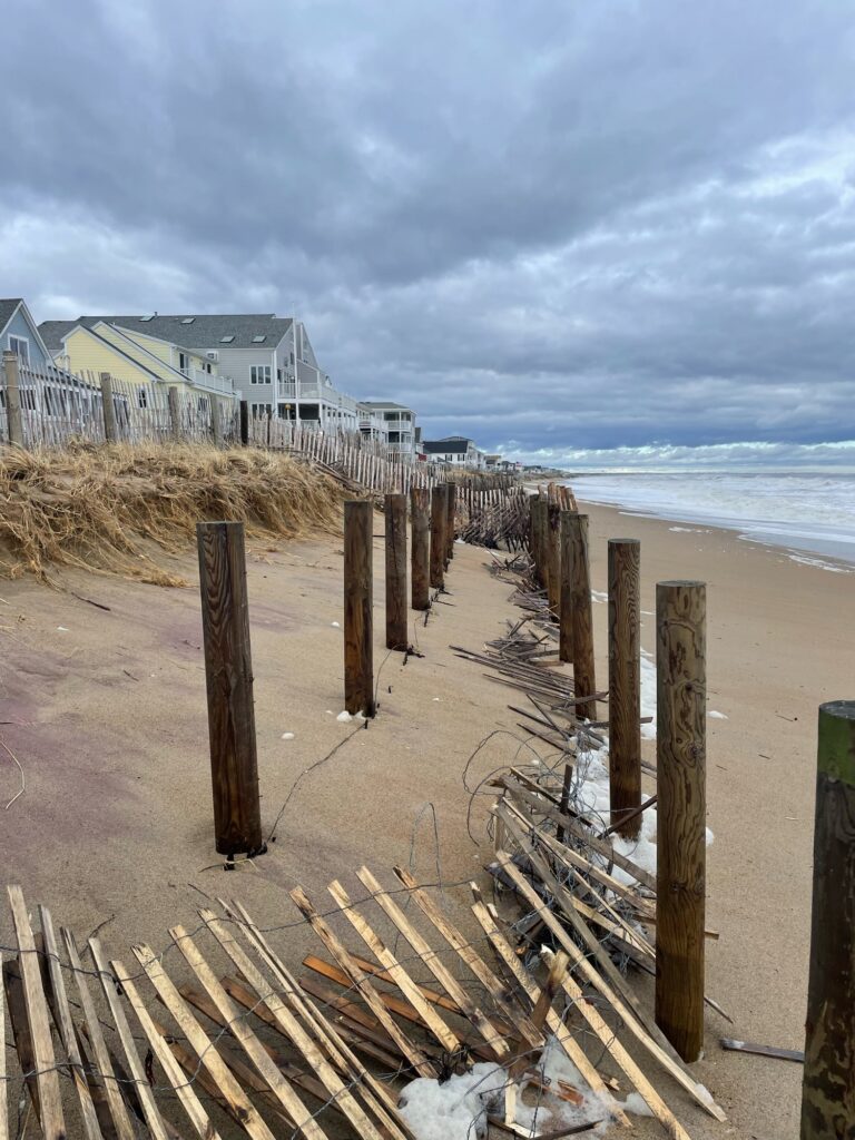 a beach with a fence and a house (MyCoast AI)